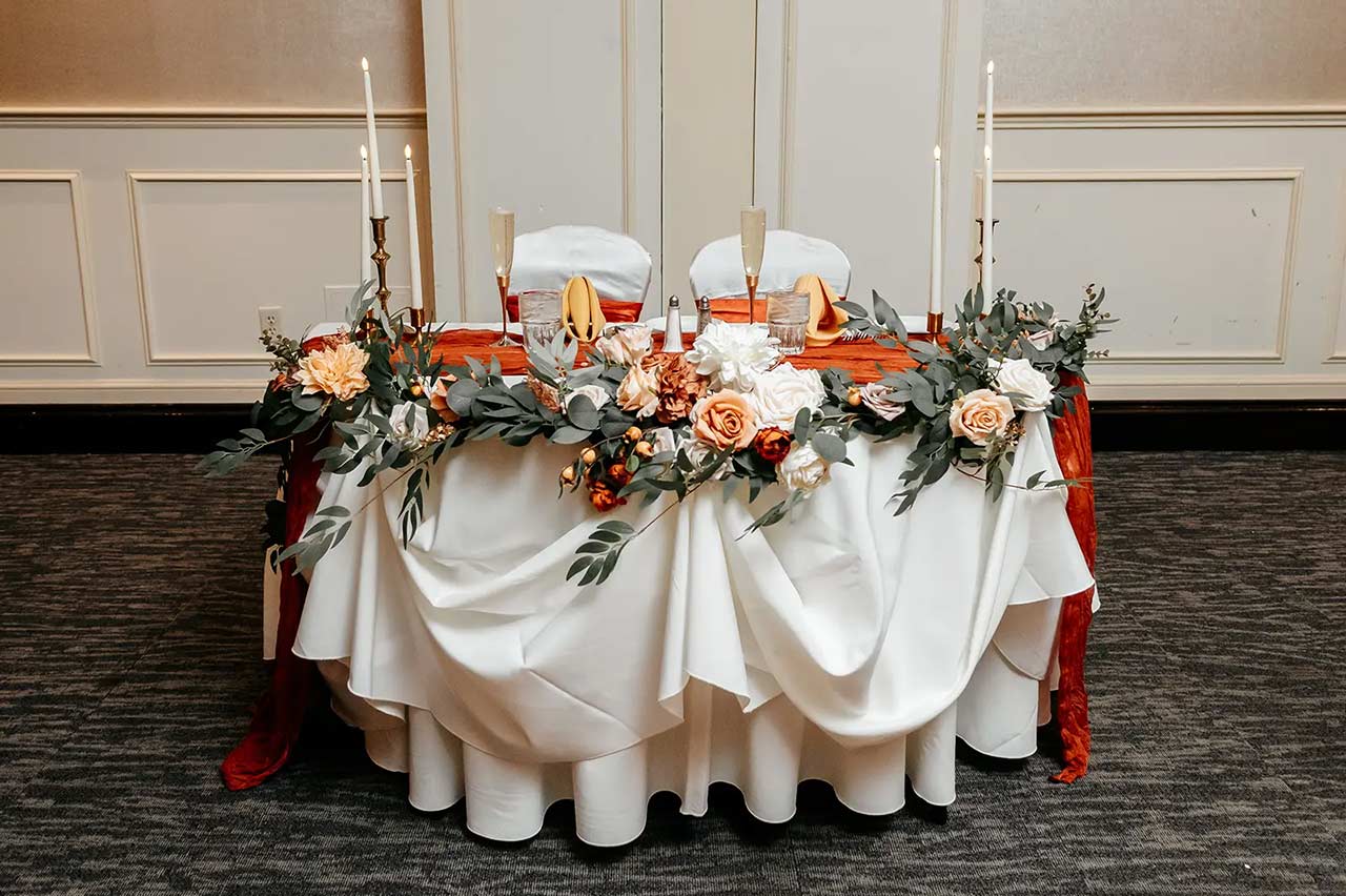 Wedding sweetheart table decorated with flowers at The Delaney House reception